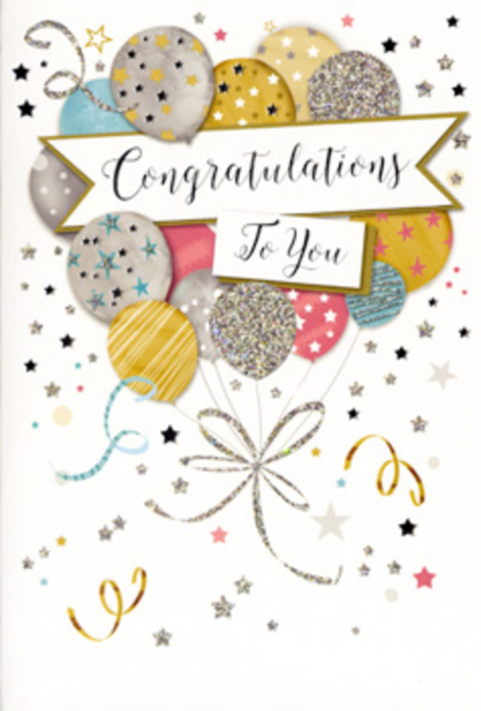 The image shows an elegant congratulations card propped upright, its artwork composed like a celebratory bouquet translated into paper and ink. At its heart is a cluster of illustrated balloons, their round forms overlapping to create gentle depth, much like layered blooms in a hand-tied arrangement. The colour palette leans towards soft luxury: muted golds and silvers, pale champagne, sky blue, blush pink, and a whisper of cool grey. Each balloon is embellished differently-some with tiny white and metallic stars, others with curved bands, dots, or glitter-like textures-giving the impression of a thoughtfully curated mix, as if each shape represents a different reason to be proud. Slim, glistening ribbons trail down from the balloons in shades of gold and silver, looping and intertwining like ribboned stems on a gift-wrapped bouquet you might collect from a Hampstead side street just off the Heath. These ribbons are echoed by swirling confetti lines and little bursts of starlike shapes that scatter across the pale background, creating a sensation of movement and celebration without any single element dominating. Across the middle, a banner with gently curling edges carries the message Congratulations To You in refined, calligraphic lettering that suggests foil-blocked or glossy ink. The mood is unmistakably festive yet polished, suited to graduations, promotions, or any cherished milestone. You can almost imagine this card resting beside a vase of fresh flowers in a Hampstead townhouse, its delicate metallic touches catching the afternoon light that filters in like a quiet applause.