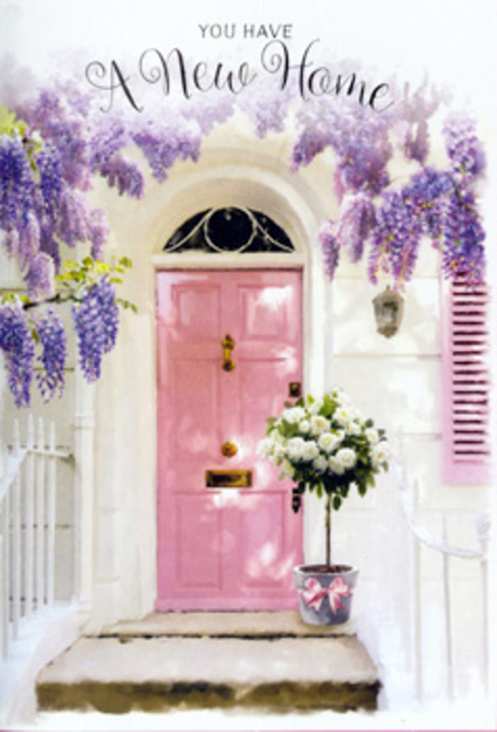 The image shows a charming Hampstead doorway that seems to exhale a soft, floral welcome, as if it has been lovingly prepared to greet someone stepping over the threshold for the first time. A pale pink door, painted in a warm, rosy hue, stands at the center, its panels catching the gentle light that sifts through trailing wisteria overhead. The surrounding walls are whitewashed and slightly textured, reflecting the glow of the day and conjuring the feel of a quiet side street not far from Hampstead Heath or Vale of Health. Above and around the doorway, generous clusters of wisteria pour downward in lush ribbons of lavender and dusty lilac, their blossoms layered and feathery, suggesting a delicate perfume that would lightly perfume the air. At ground level, resting squarely on the stone step, a simple grey metal bucket becomes a focal point of tenderness. It brims with creamy white roses, fully open and cushiony, each flower ringed by soft green leaves and fine stems that give the arrangement fullness and shape. Around the bucket's base, a satin pink ribbon has been tied in a neat bow, its sheen catching the light and echoing the door's pastel tone. The interplay of colour - pink, white, lavender, and soft green - creates a harmonious scene, like a carefully curated housewarming gift from a local Hampstead florist. The mood is one of gentle excitement and reassurance, as though the bouquet has arrived just in time to welcome the new homeowners back from a stroll along Hampstead High Street, inviting them to pause, breathe, and feel that this place will hold their memories for years to come.