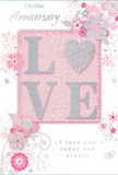 This anniversary card design offers a quiet yet deeply romantic celebration of lasting partnership, with colours and textures that echo the soft pastels found in many Hampstead Flowers arrangements. At the centre of the card, the word LOVE appears in generous, raised letters, each one coated with a smooth layer of glitter that sparkles gently when it catches the light, reminiscent of candlelight glinting off glass vases at an intimate dinner. The O in LOVE is transformed into a shimmering heart, textured in silver so it stands out as the focal point, suggesting warmth and devotion. Surrounding this central typography, a scatter of delicate blossoms in blush pink, mauve, and soft ivory drifts across the surface like petals falling from a hand-tied bouquet. The flowers have a slightly watercolour softness, their outlines fluid and their colours gently blended, creating an impression of movement and grace. Fine swirling lines, tiny petals, and discrete butterfly motifs weave between the blooms, adding a sense of whimsical motion, much like the breeze that moves through Hampstead Heath in spring. The background is washed in pale pink and subtle grey tones, anchoring the design in a calm, affectionate mood. Elegant script text-phrases such as On Our Anniversary and I love you today and always-rests above and below the main motif, the lettering slim and flowing, as if handwritten in a personal note. Together, the textures, pastel shades, and romantic wording create an image of an anniversary card that feels both intimate and refined, perfect for honouring years of shared life in and around Hampstead's village-like streets.